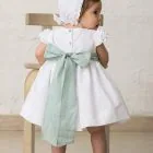 white baby bonnet with ruffle
