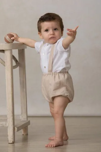beige baby bloomers with linen suspenders