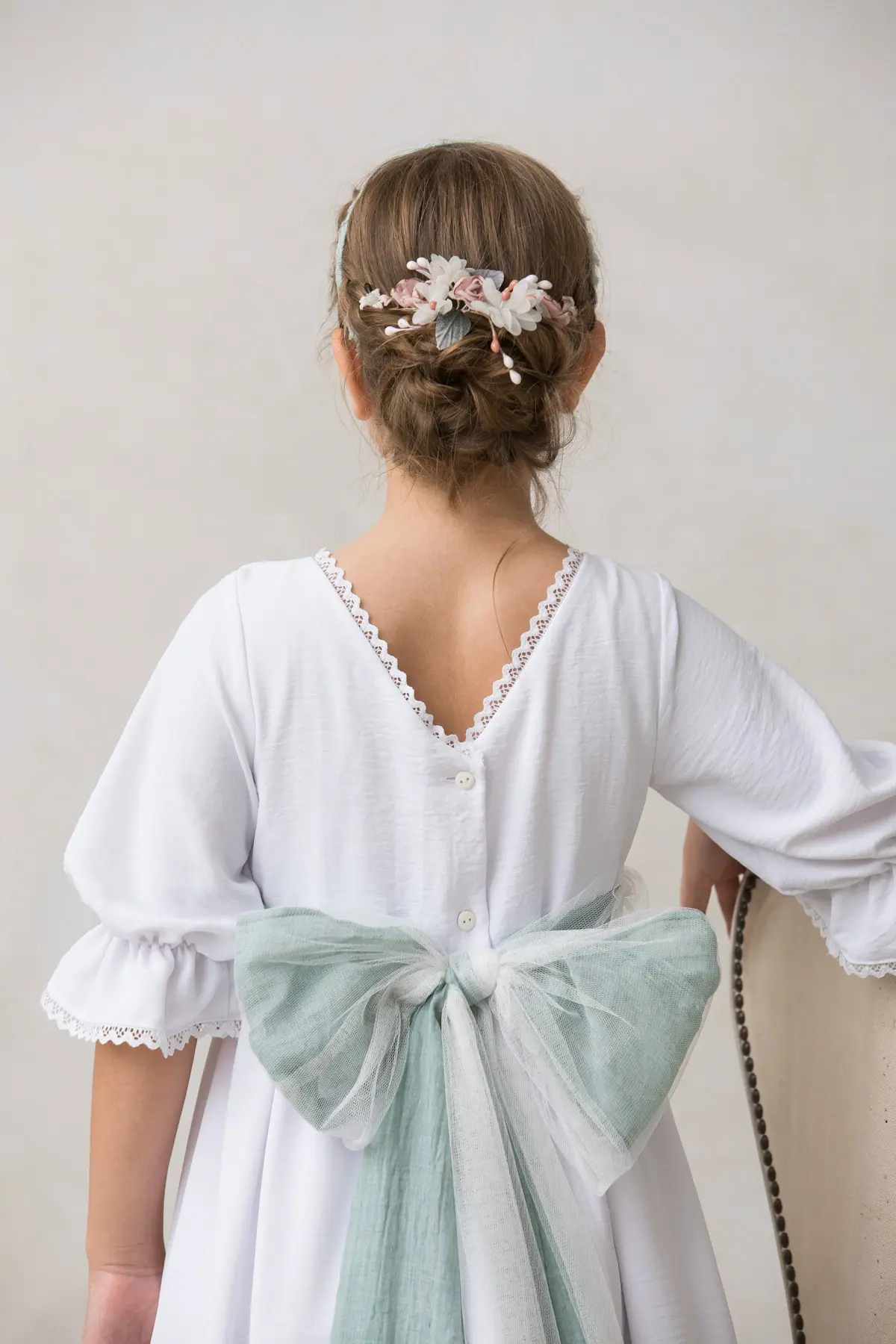 half crown of flowers for a girl's hair for a ceremony, white roses
