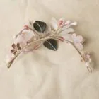 half crown of hair with white and pink flowers