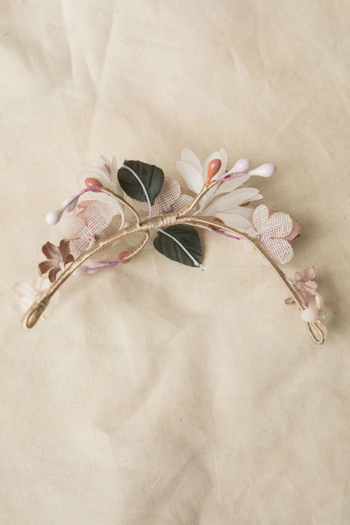 half crown of hair with white and pink flowers